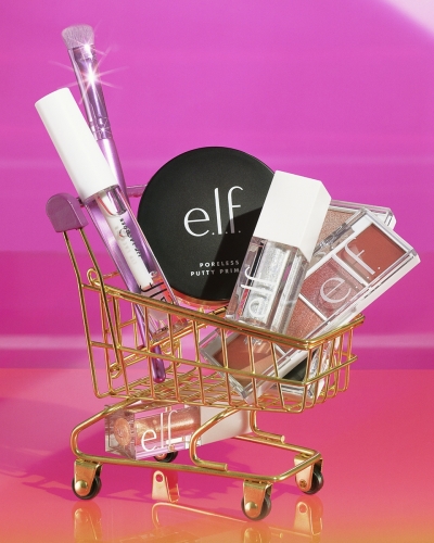Still life of Lip Lacquer in Clear (22181), Liquid Glitter Eyeshadow in Disco Queen (83440), Poreless Putty Primer (85912), Bite Size Eyeshadow in Berry Bad (29922) and Rose Water (59924) in Golden Cart -
